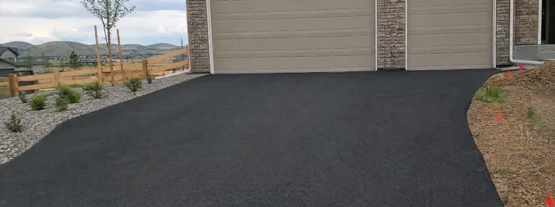 Asphalt paving crew working on a driveway in Broomfield Colorado