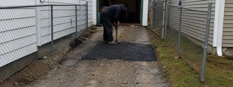 Asphalt paving crew working on a driveway in Northglenn Colorado