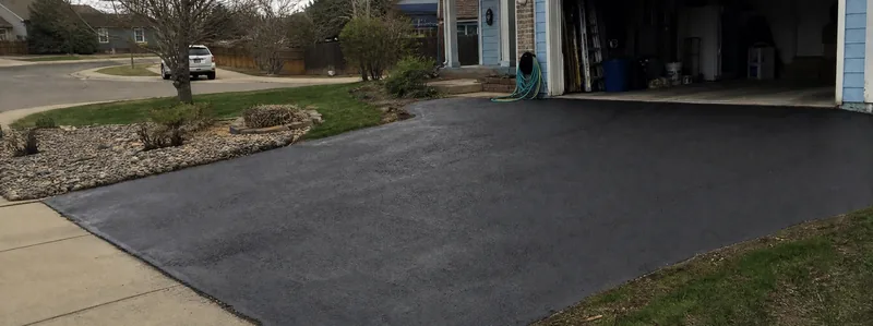 Asphalt paving crew working on a driveway in Westminster Colorado
