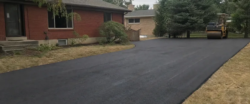 Freshly paved asphalt driveway in Arvada, Colorado on an overcast afternoon