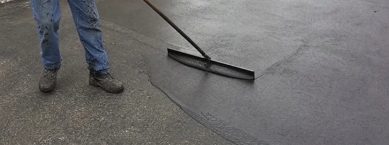 Driveway sealcoating application squeegee work in Arvada Colorado