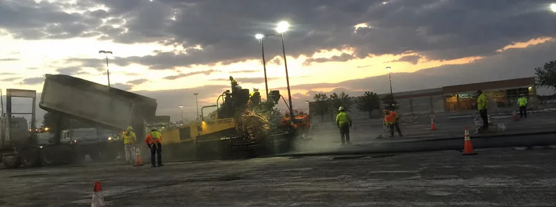 Commercial asphalt parking lot paving crew working at night in Arvada Colorado
